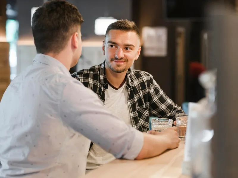 two-young-male-friends-enjoying-glasses-drink_23-2147859515 (1)